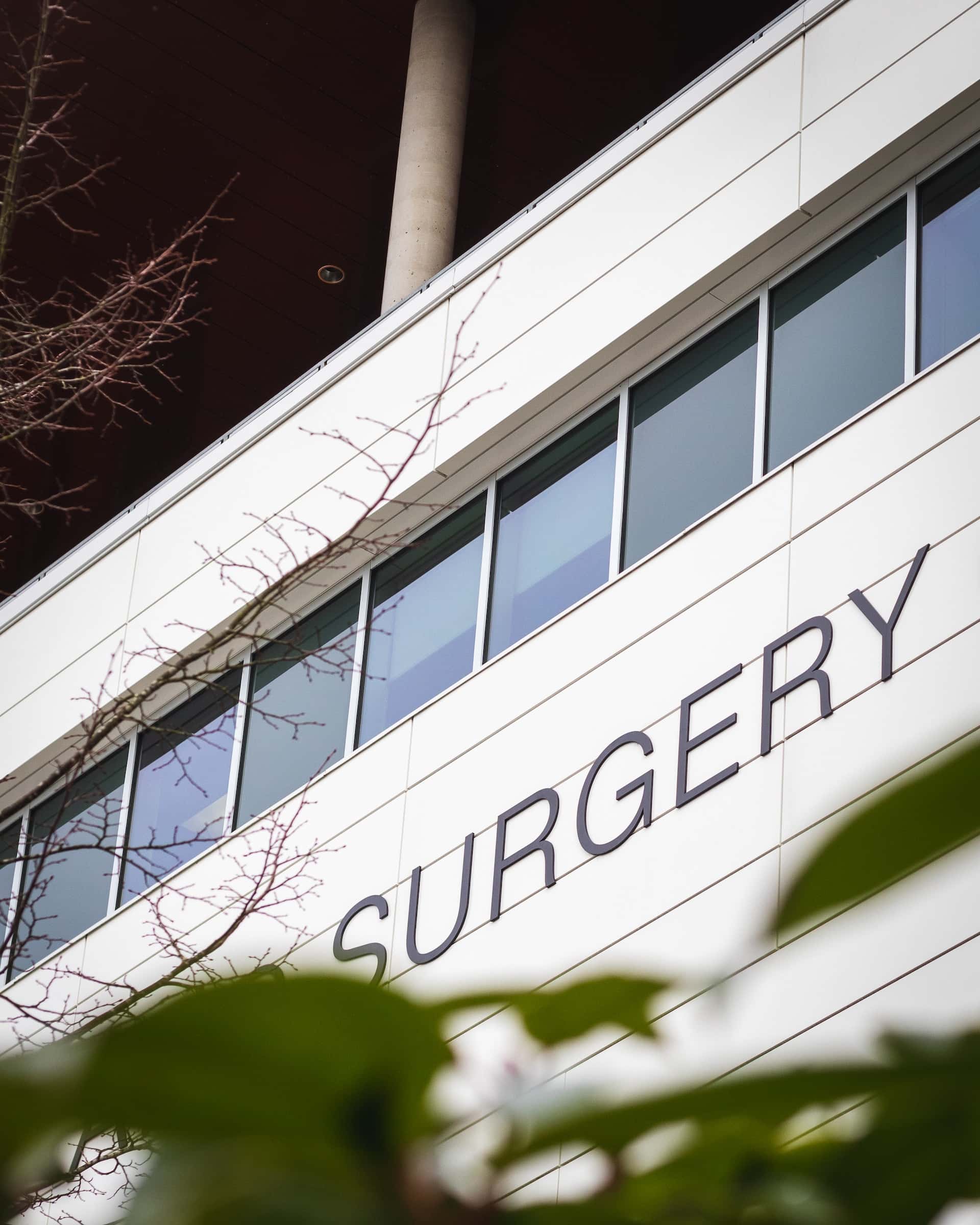 Building with windows and a sign "Surgery"