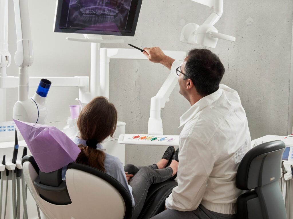 Dentist showing a child her dental X-ray.