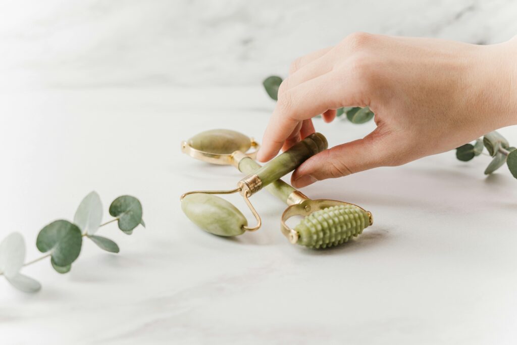 womans hand placing a derma roller on a counter top