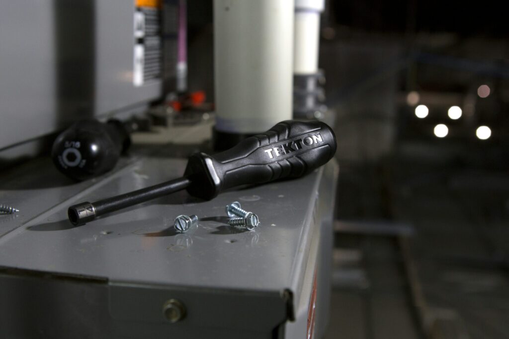 Screw driver resting on a surface at an HVAC job