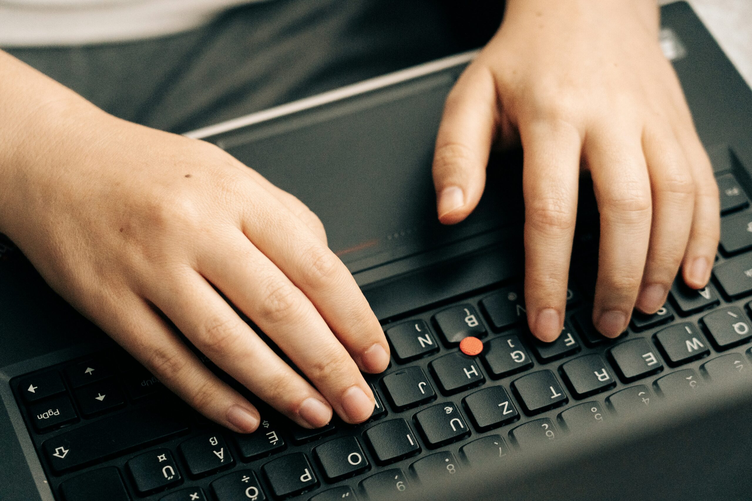 Hands typing on computer
