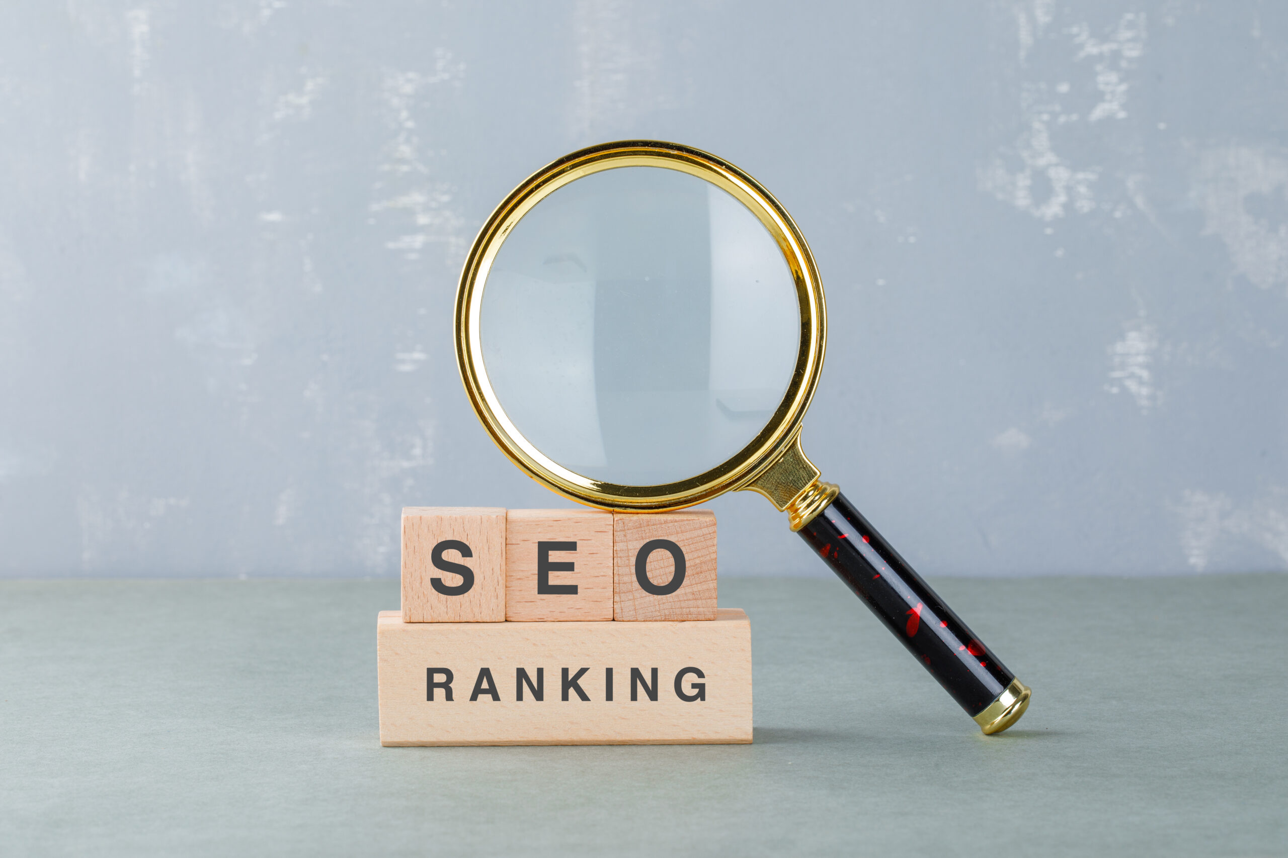 Conceptual of seo analysis and business. with wooden blocks with words on a magnifying glass