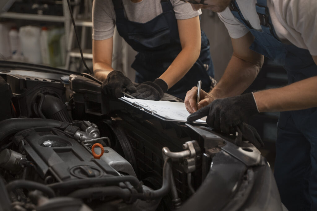 Mechanics working on car