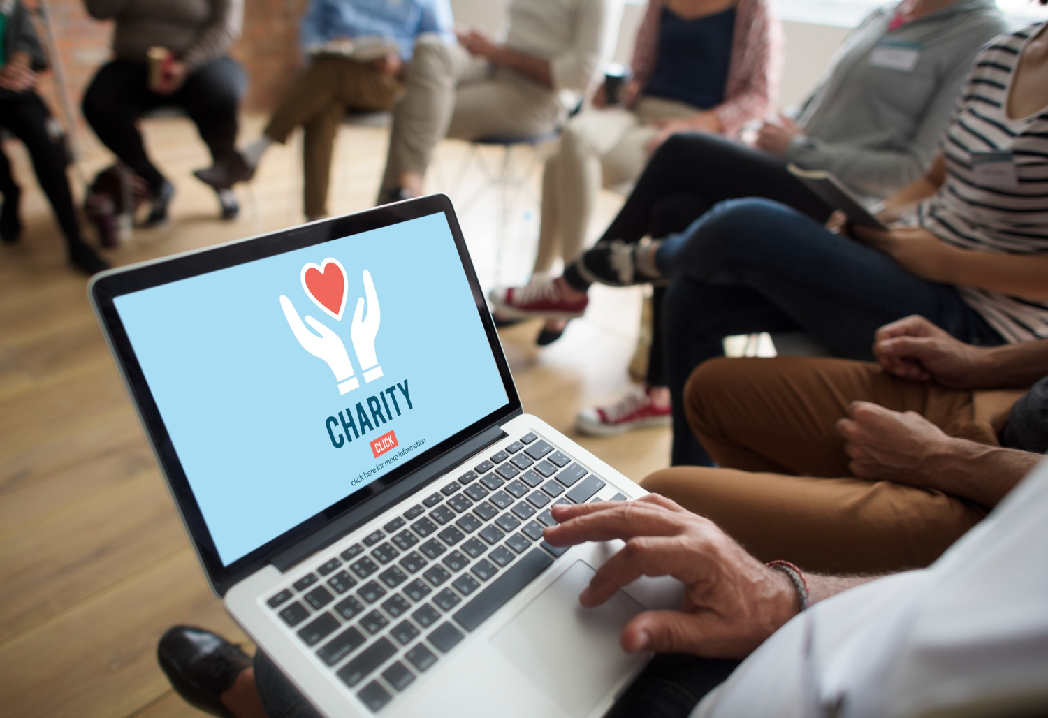 nonprofit person looking at a laptop with charity on the screen
