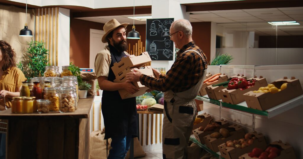 A farmer vendor is giving a man his good in a local place