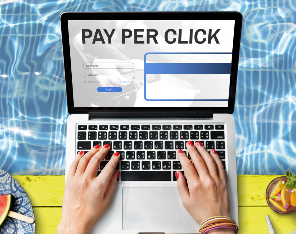 Person typing on a laptop displaying “Pay Per Click,” representing PPC digital advertising and online marketing campaigns.