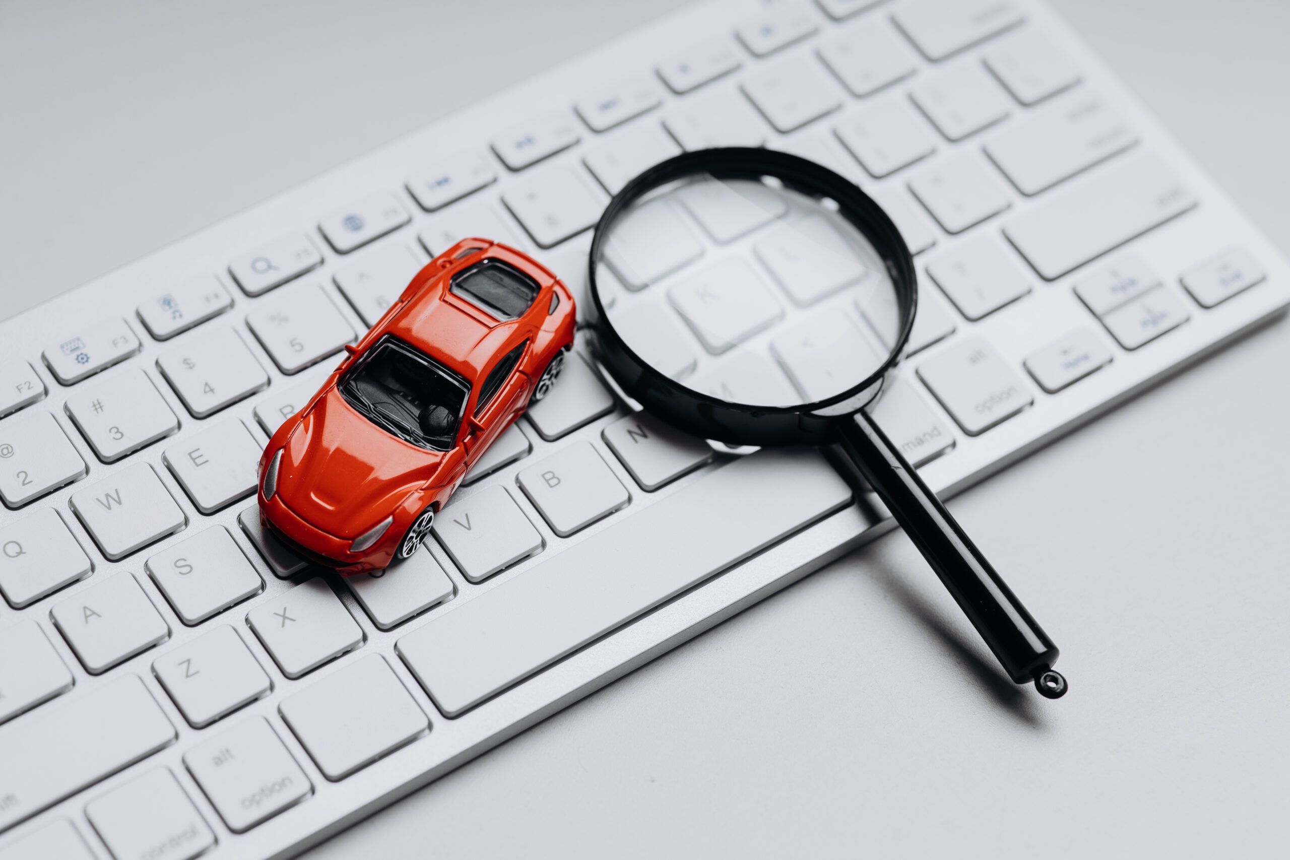 Red toy car on a keyboard.
