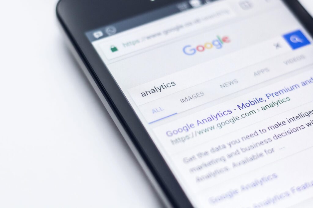 Smartphone displaying a Google search for analytics, highlighting website performance and data tracking tools.