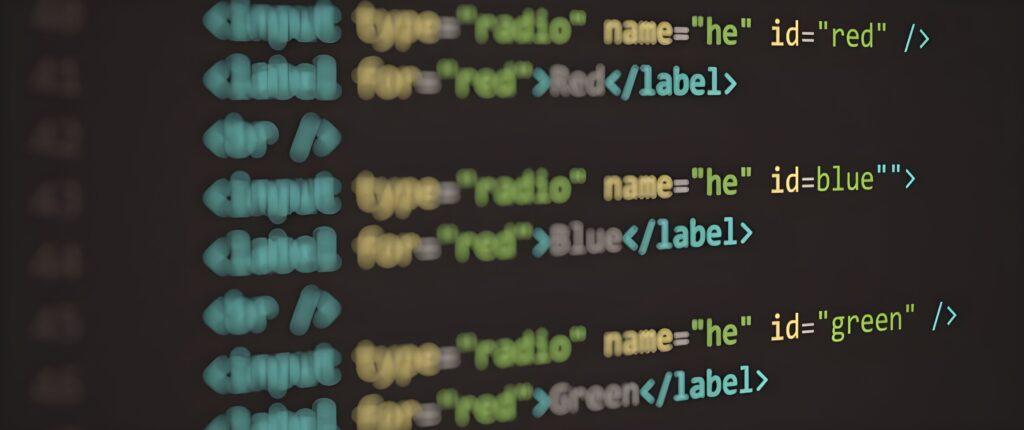 Close-up of colorful HTML code displayed on a dark computer screen, showing label elements with red, blue, and green IDs.