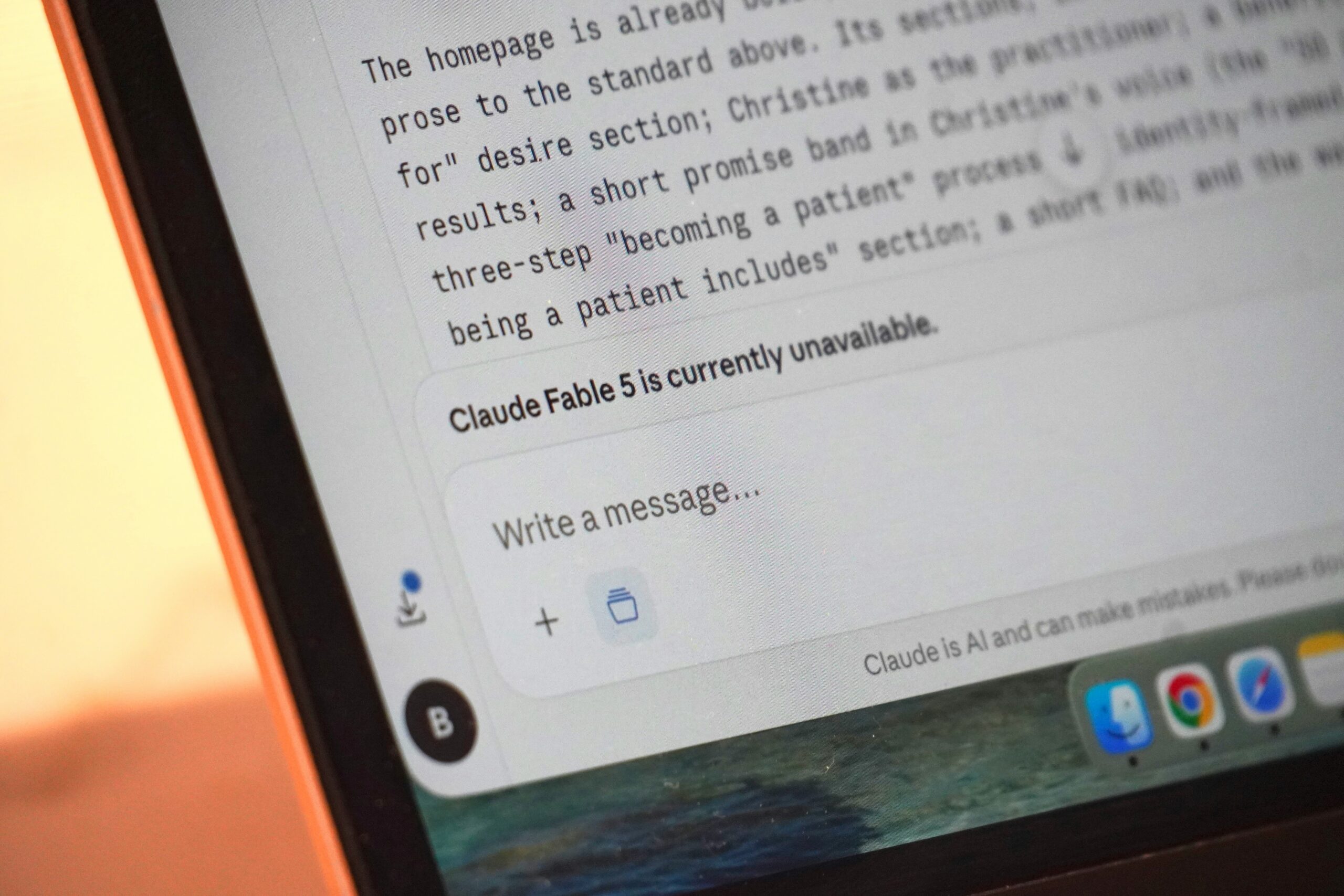 Close-up of a laptop screen displaying a Claude AI chat interface with a message stating, “Claude Fable 5 is currently unavailable.”