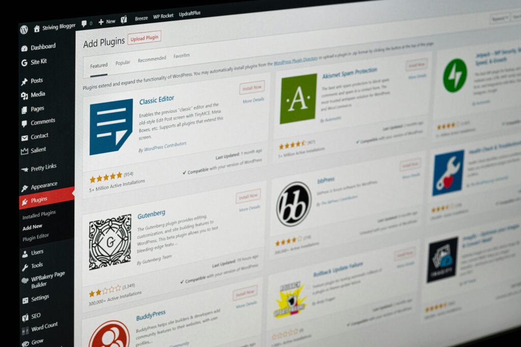 WordPress admin dashboard showing the Add Plugins page with plugin listings, ratings, installation options, and the navigation menu on the left.