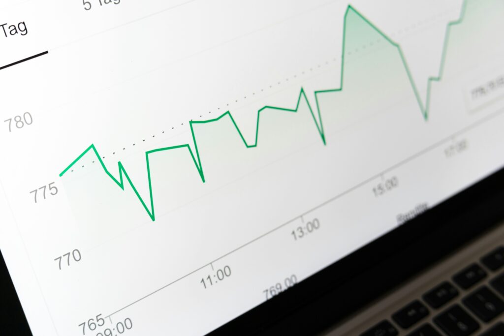 Analytics dashboard showing a green line graph tracking performance trends over time on a laptop screen.