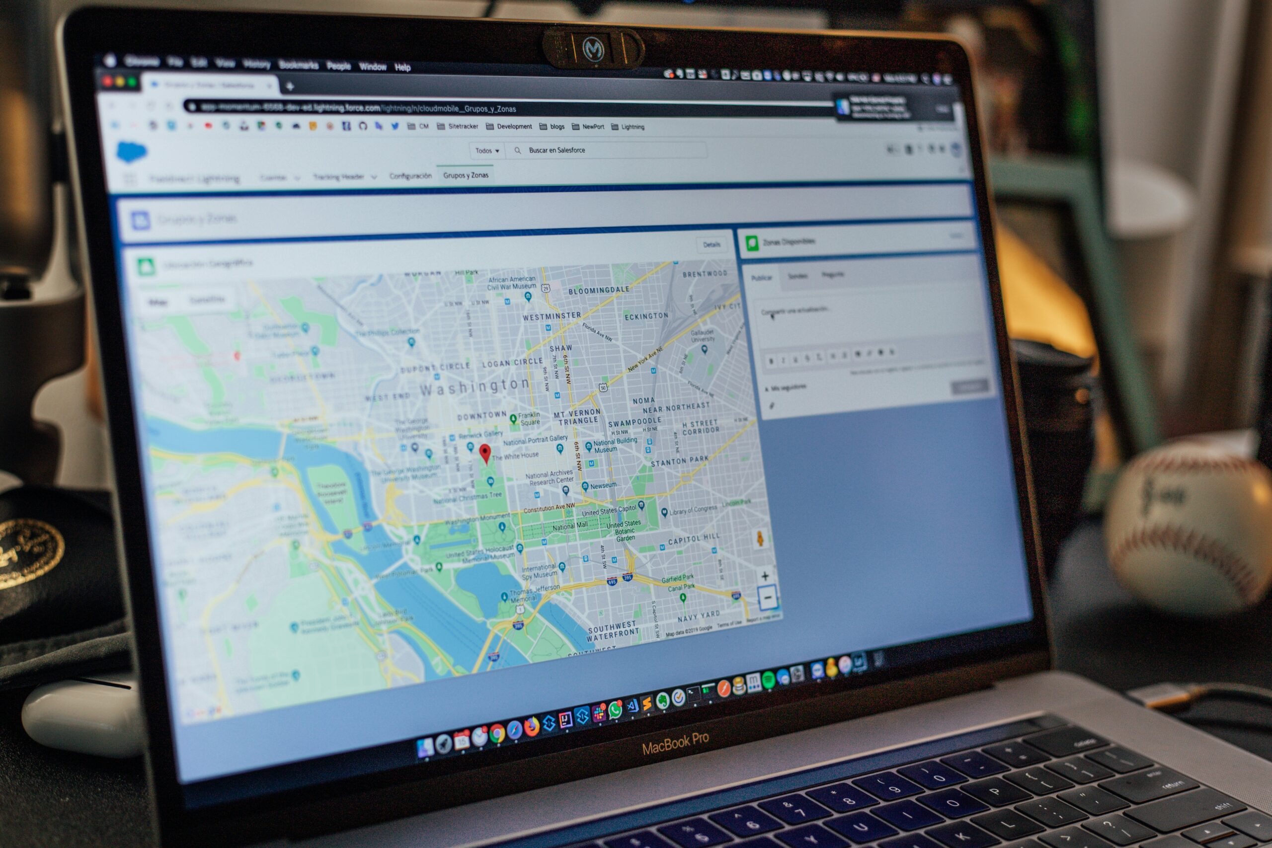 Laptop displaying a digital map of Washington, D.C. with location markers and geographic mapping tools open on the screen.