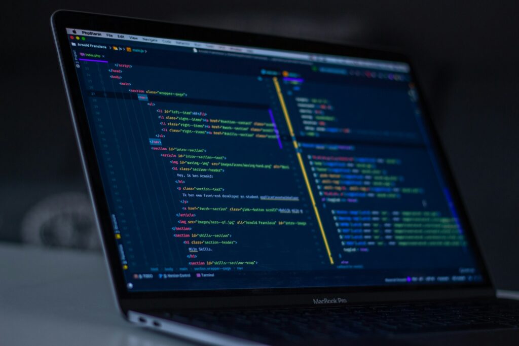 MacBook Pro showing lines of code on screen